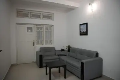 a living room with a couch and a table at Wayanad Cliff Hotel Apartments in Kalpetta