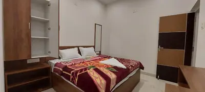 a small bedroom with a bed and a mirror at Anya Paradise in Ooty