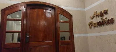 a wooden door in the corner of a room at Anya Paradise in Ooty