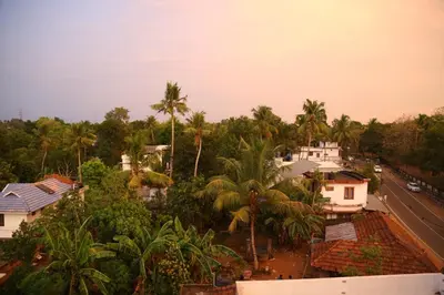 an aerial view of a city with palm trees at Kurianplackal Residency in Alwaye
