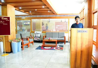 a man standing behind a podium in a waiting room at HOTEL JAAS CONTINENTAL in Edappāl