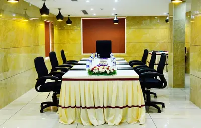 a conference room with a long table and chairs at HOTEL JAAS CONTINENTAL in Edappāl