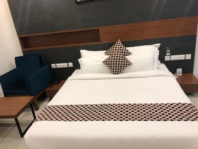a bedroom with a large bed with two pillows at HOTEL JAAS CONTINENTAL in Edappāl