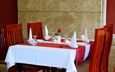 a table with a red and white table cloth and a red and white table cloth at HOTEL JAAS CONTINENTAL in Edappāl