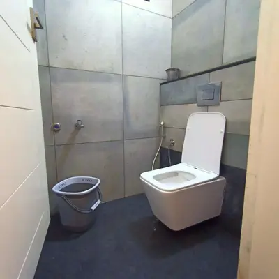 a bathroom with a toilet and a bidet at Wayanad Empire Colonial Villa in Kalpetta