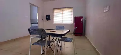 a kitchen with a table and chairs in a room at Wayanad Empire Colonial Villa in Kalpetta