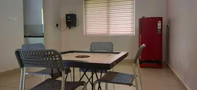 a kitchen with a table and chairs and a red refrigerator at Wayanad Empire Colonial Villa in Kalpetta