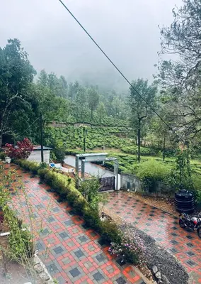 a brick walkway with a building on a hill at Edenvilla in Vālpārai