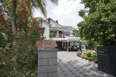 a house with a sign in front of a driveway at Springfield service villa in Mananthavady