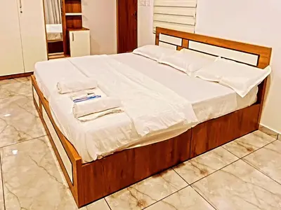 a bed with white sheets and towels on it at Springfield service villa in Mananthavady