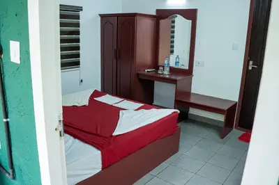 a small bedroom with a bed and a mirror at The Nest Thattekad in Thattakād