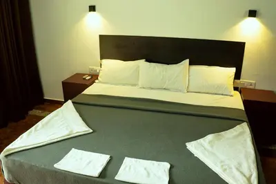 a bed in a hotel room with two towels on it at The Nest Thattekad in Thattakād