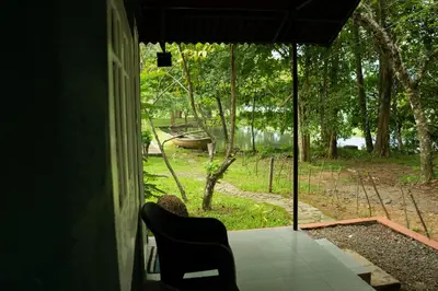 a room with a door open to a view of a river at The Nest Thattekad in Thattakād