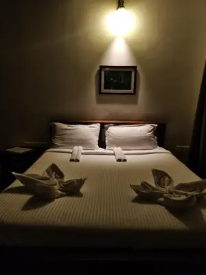 a bedroom with a bed with three bowls on it at Moksha at Infinity Valley in Kotagiri