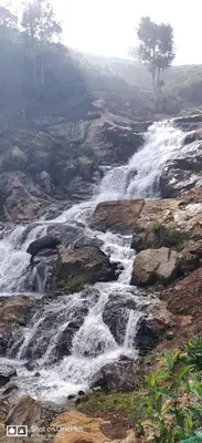 a waterfall on the side of a mountain at Moksha at Infinity Valley in Kotagiri