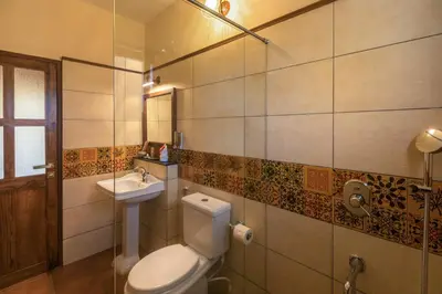 a bathroom with a toilet and a sink at Willow Hill by Nature Resorts and Stays in Ooty