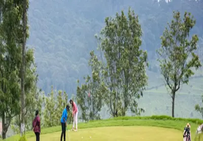 a group of people playing golf on a field at Willow Hill by Nature Resorts and Stays in Ooty