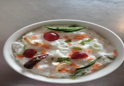 a bowl of oatmeal with cherries and other vegetables at Willow Hill by Nature Resorts and Stays in Ooty