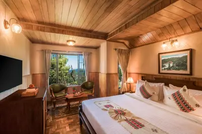 a hotel room with a bed and a tv at Willow Hill by Nature Resorts and Stays in Ooty