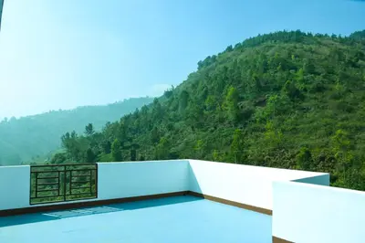 a balcony with a view of a mountain at JDP Villa 2 Bhk House in Ooty