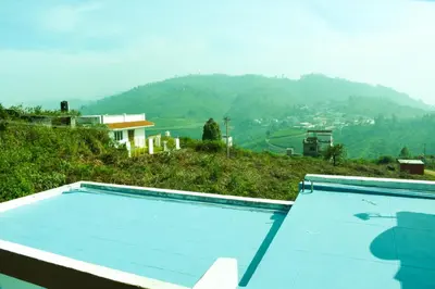 a swimming pool with a view of a mountain at JDP Villa 2 Bhk House in Ooty