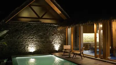 a house with a swimming pool and a table and chairs at Maayaa riverside villa by KPM Tripenta in Attappādi