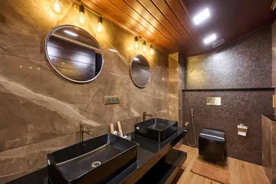 a bathroom with two sinks and a mirror at Maliekal Heritance Cherai Beach Cochin in Cherai Beach