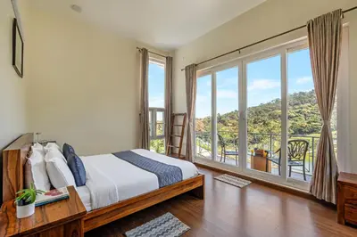 a bedroom with a bed and a large window at Kalpavriksha 4BR Luxury Villa - Xplore Indo in Kotagiri
