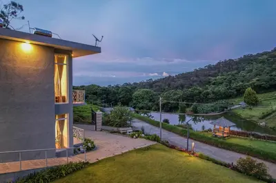 a house with a view of a river and a hill at Kalpavriksha 4BR Luxury Villa - Xplore Indo in Kotagiri