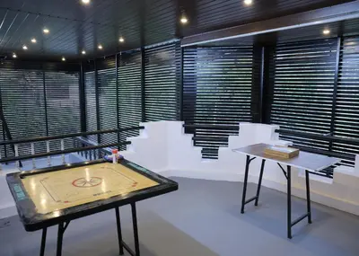 a room with a table with a tennis ball on it at Malpans Mansion Villa in Nedumbassery