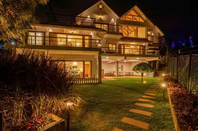 a house with lights in the yard at night at amã Stays & Trails - Werifesteria, Coonoor in Coonoor
