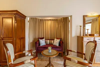 a living room with a couch and two chairs at amã Stays & Trails - Werifesteria, Coonoor in Coonoor
