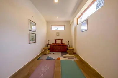 a hallway with a bed and a window at amã Stays & Trails - Werifesteria, Coonoor in Coonoor