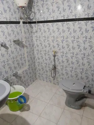 a bathroom with a toilet and a sink at Malpans Mansion in Nedumbassery