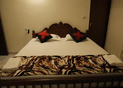 a close up of a bed in a bedroom at Malpans Mansion in Nedumbassery