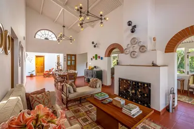 a living room with a fireplace and a table at amã Stays & Trails - Aberdeen, Coonoor in Wellington Town