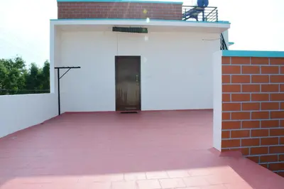 a garage with a door in a brick building at Kailash Guest Home in Mysore