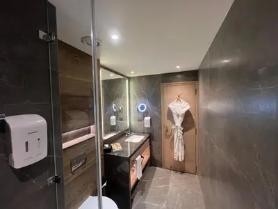 a bathroom with a sink and a shower stall at O by Tamara Coimbatore in Coimbatore