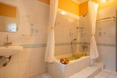 a bathroom with a tub and a sink at Misty Heights by The Sanihara in Vayittiri