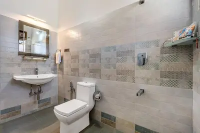 a bathroom with a toilet and a sink at StayVista at 5 Rooms at The West Wind - Ooty Comp Breakfast in Ooty