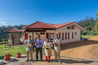 a group of people standing in front of a house at StayVista at 5 Rooms at The West Wind - Ooty Comp Breakfast in Ooty