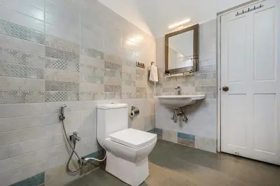 a bathroom with a toilet and a sink at StayVista at 5 Rooms at The West Wind - Ooty Comp Breakfast in Ooty
