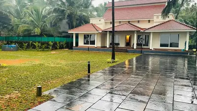 a house in the rain with a house at Seagrove Villa in Kappad