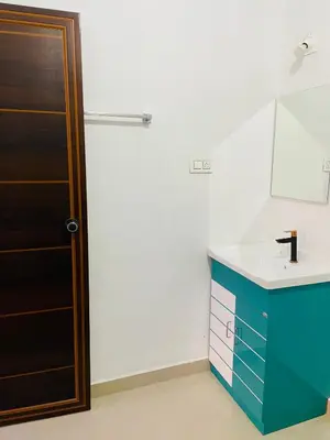 a bathroom with a sink and a mirror at Flowers Villa in Ambalavayal