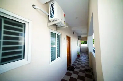 a hallway of a house with a checkered floor at KUKAL CASTLE in Tiruppūr