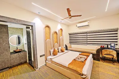 a bedroom with a large bed and a desk at Kaadgal Resort in Kanakapura