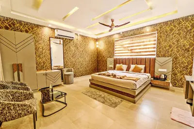 a bedroom with a bed and a couch and a chair at Kaadgal Resort in Kanakapura