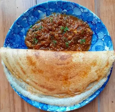 a blue plate of food with a bowl of food at Bhuvanam homestay in Kalpetta