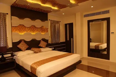 a bedroom with a large bed and a mirror at SBS Grand in Coimbatore