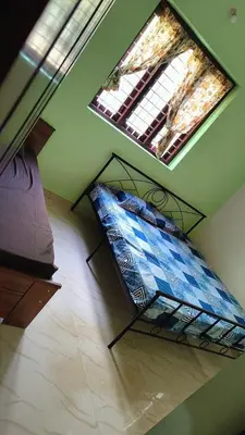 a bed in a room with two skylights at Dragster Homes in Kizhake Chālakudi